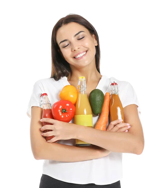 Young woman with bottles of different healthy juice on white background — Stock Photo, Image