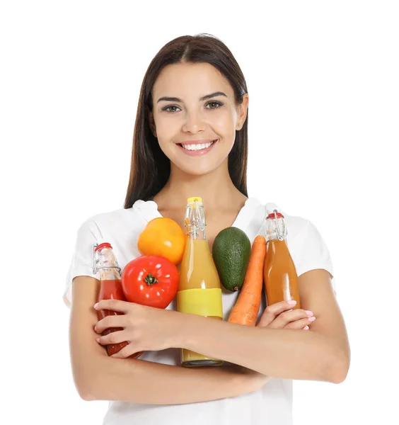 Young woman with bottles of different healthy juice on white background — Stock Photo, Image