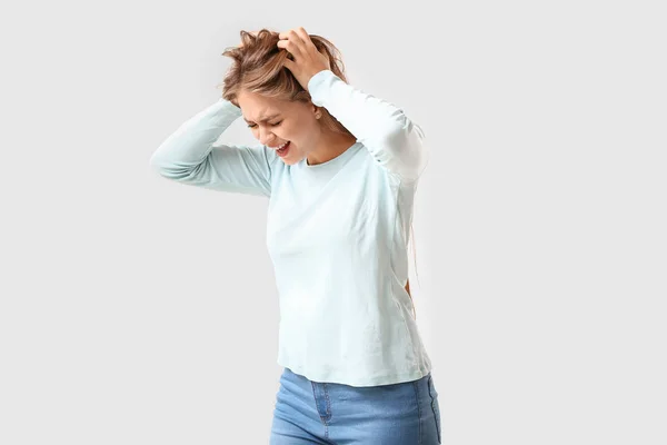 Woman having panic attack on light background — Stock Photo, Image