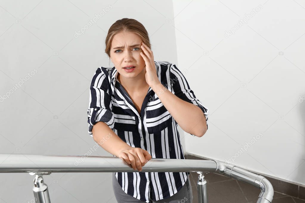 Woman having panic attack in the stairway