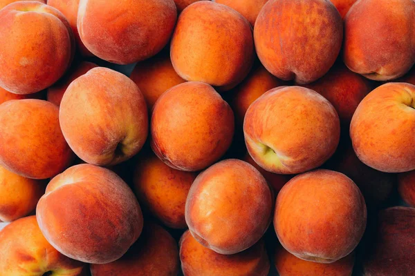 Many ripe peaches as background — Stock Photo, Image