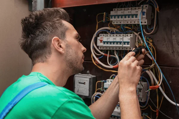 Elektrikář instalující poplašný systém v rozvodné desce — Stock fotografie