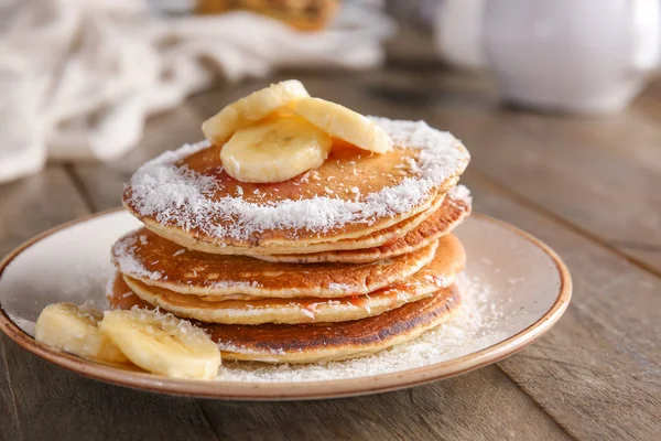 Tasty pancakes with banana on plate — Stock Photo, Image