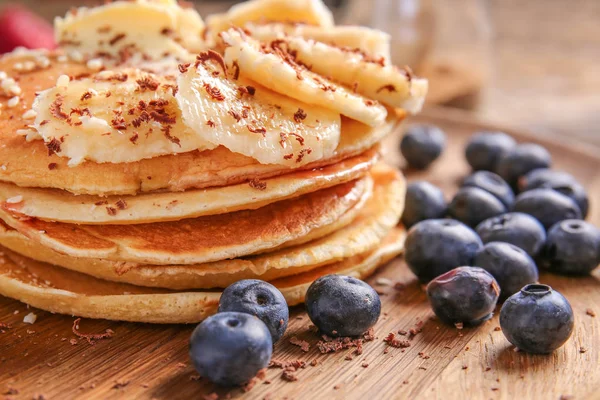 Tasty pancakes, banana and blueberry on plate, closeup