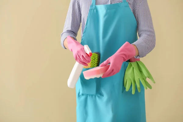 Woman with cleaning supplies on color background, closeup — Stock Photo, Image