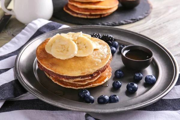 Tasty pancakes with banana and berries on tray — Stock Photo, Image