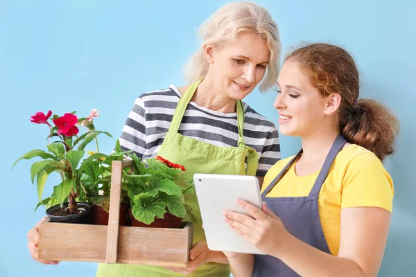 Portrait of female gardeners on color background — Stock Photo, Image