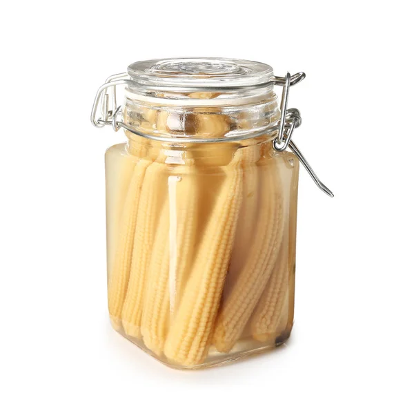 Jar with canned corn cobs on white background