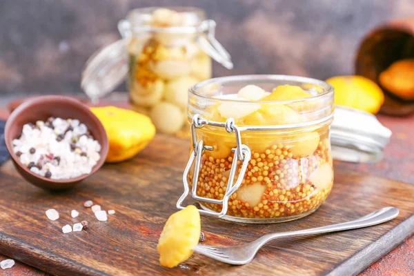 Jar with canned squashes on wooden board — Stock Photo, Image