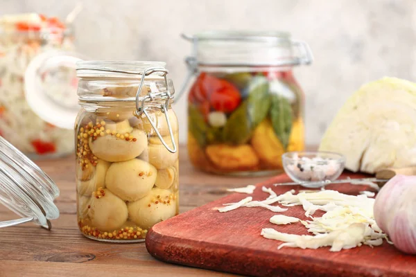 Jar with canned mushrooms on wooden table — Stock Photo, Image