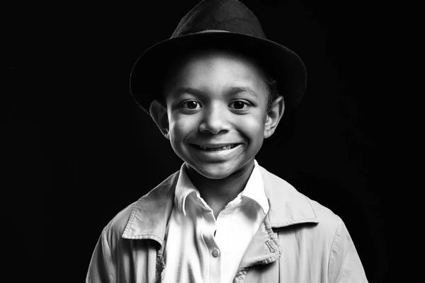 Black and white portrait of cute African-American boy on dark background — Stock Photo, Image