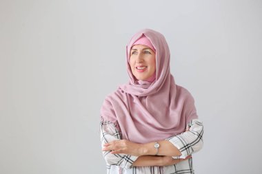 Hafif arka planda Müslüman orta yaşlı kadın portresi