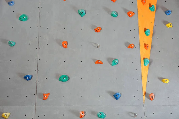 Wall with climbing holds in gym — Stock Photo, Image
