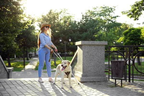 Young blind woman with guide dog outdoors — Stock Photo, Image
