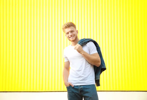 Man in stylish t-shirt on color background — Stock Photo, Image