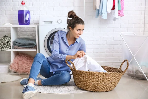 Mooie jonge vrouw doet wasserij thuis — Stockfoto