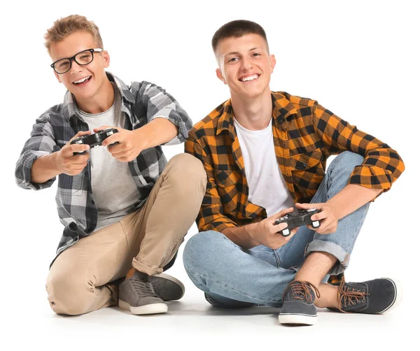 Teenage boys playing video game on white background — Stock Photo, Image