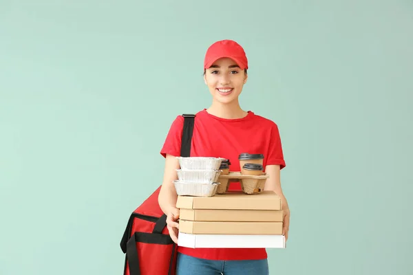 Trabalhadora do serviço de entrega de alimentos no fundo de cor — Fotografia de Stock