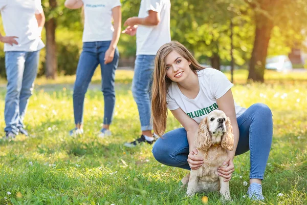 Female volunteer with cute dog outdoors