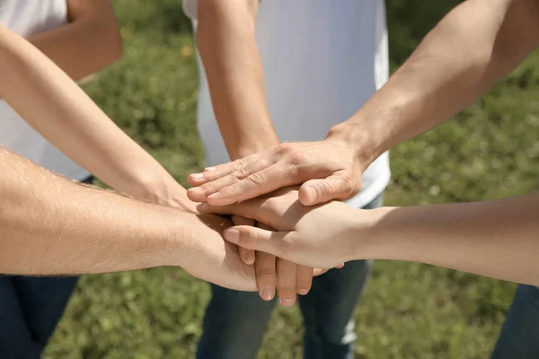 Grupp frivilliga som sätter händer tillsammans utomhus — Stockfoto