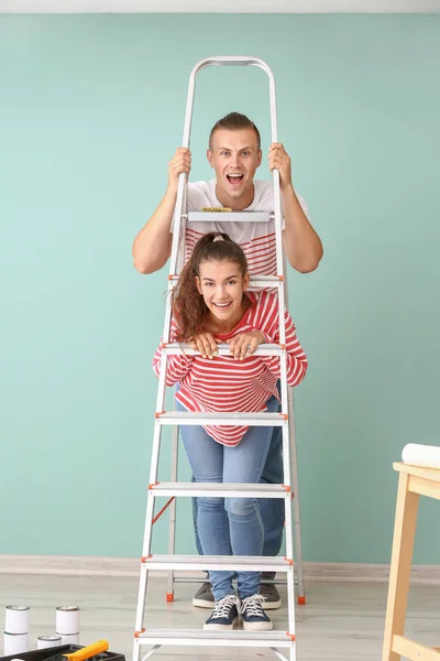 Happy young couple doing repair in their new house — Stock Photo, Image