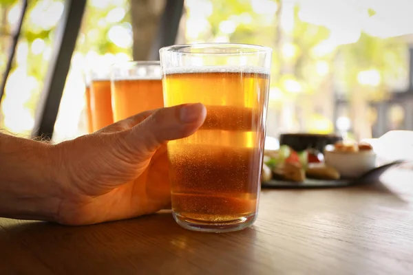 Man drinking fresh beer in pub, closeup — Stock Photo, Image