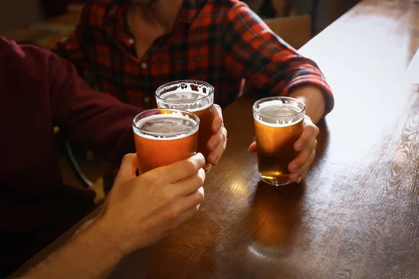 Friends drinking fresh beer in pub — Stock Photo, Image