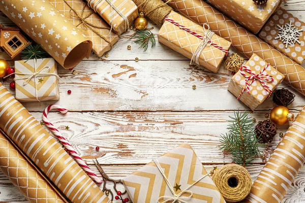 Frame made of beautiful Christmas gift boxes and wrapping paper on white wooden background — Stock Photo, Image