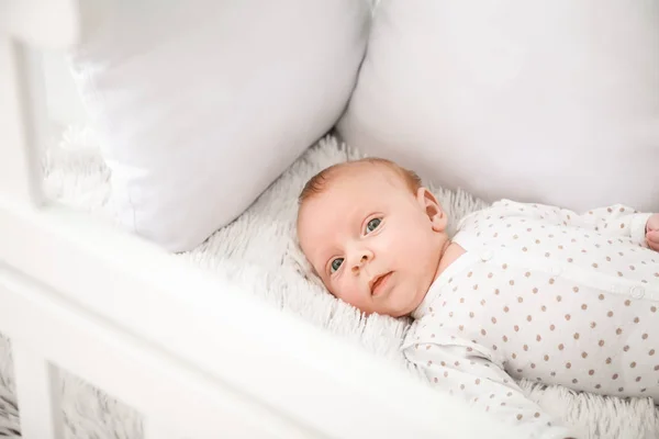 Cute little baby lying in crib — Stock Photo, Image