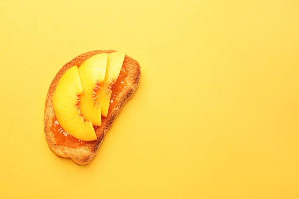 Tasty toasted bread with fruit jam on color background — Stock Photo, Image