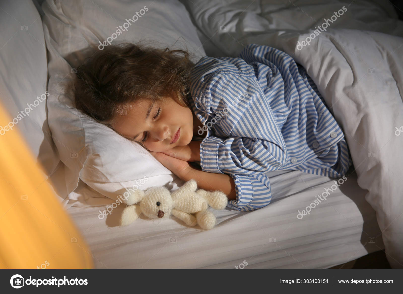 Cute little girl sleeping in bed at night Stock Photo by ©serezniy