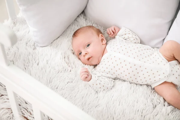 Cute little baby lying in crib — Stock Photo, Image