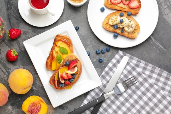 Plate with tasty sandwiches and cup of tea on table — Stock Photo, Image