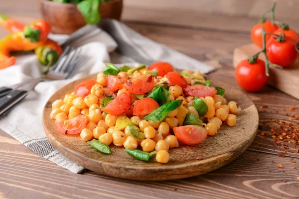 Plate with tasty chickpea salad on table — Stock Photo, Image