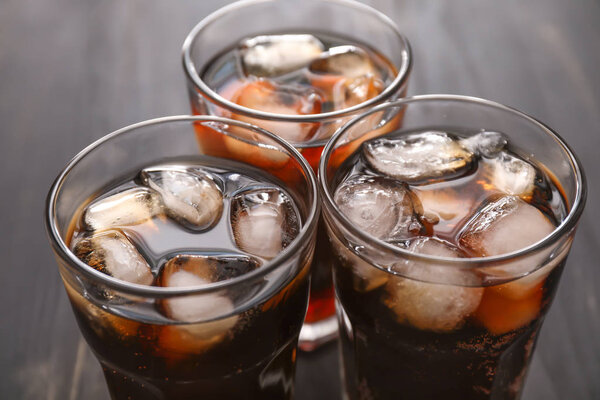 Glasses of cold cola on table, closeup