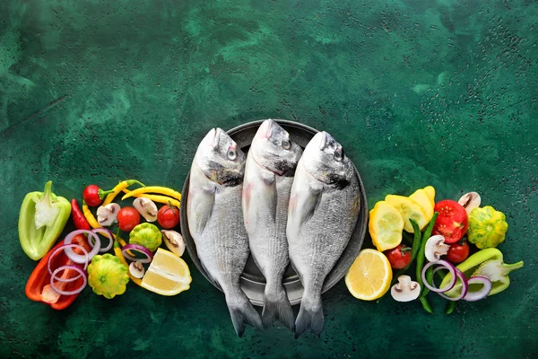 Fresh dorado fish and ingredients on color background — Stock Photo, Image