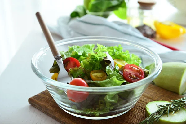 Bowl with tasty salad on kitchen table, closeup — Stock Photo, Image