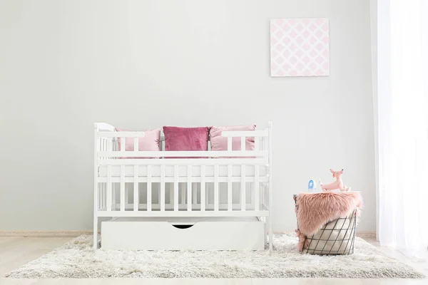 Interior of light modern baby room with crib — Stock Photo, Image