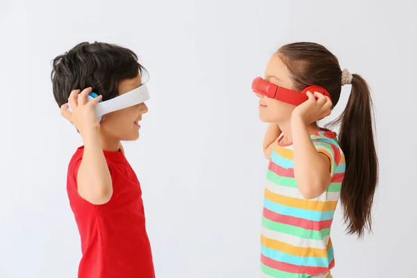 Cute little children with headphones having fun on light background — Stock Photo, Image