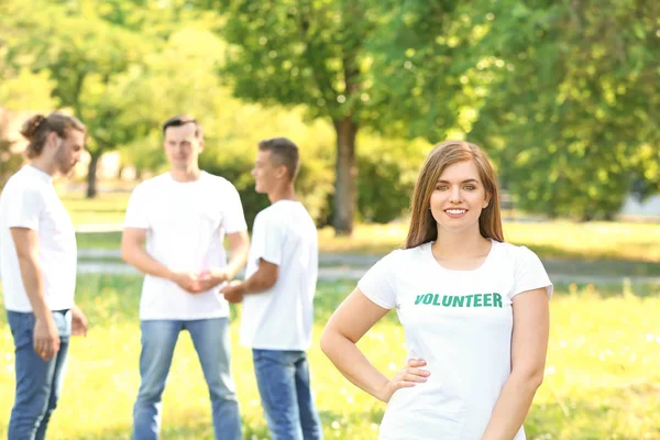 Portrait of young female volunteer outdoors