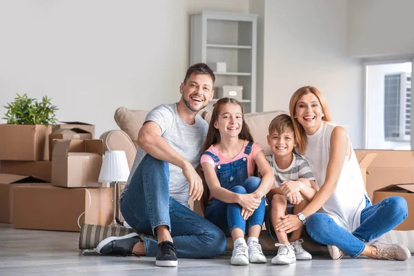 Happy family with belongings in their new house — Stock Photo, Image