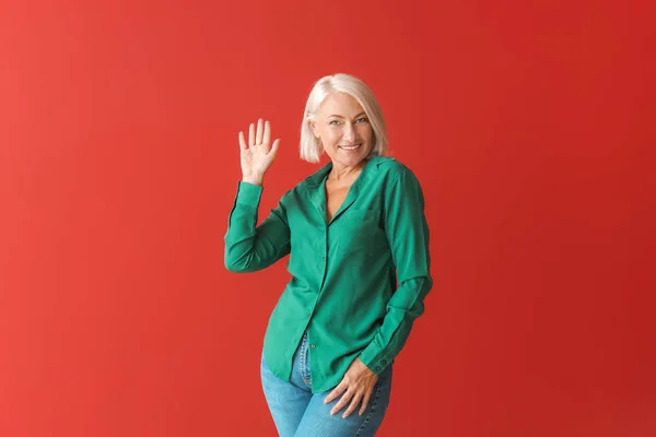 Stylish mature woman on color background — Stock Photo, Image