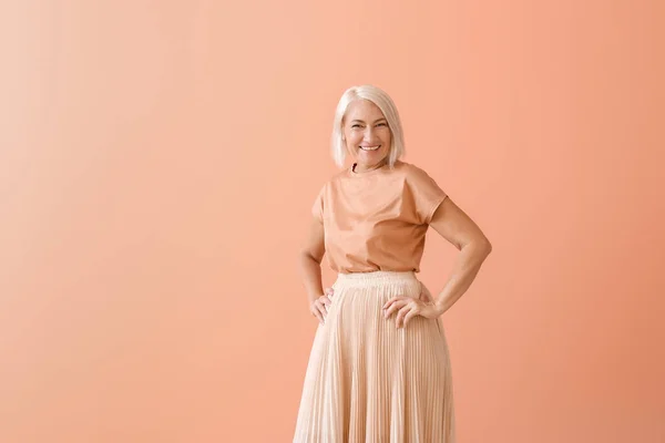 Stylish mature woman on color background — Stock Photo, Image