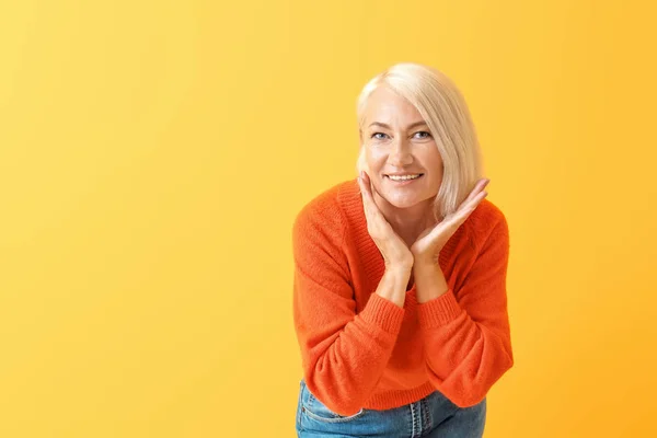 Stilvolle reife Frau auf farbigem Hintergrund — Stockfoto