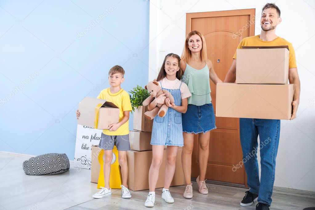 Happy family with belongings in their new house