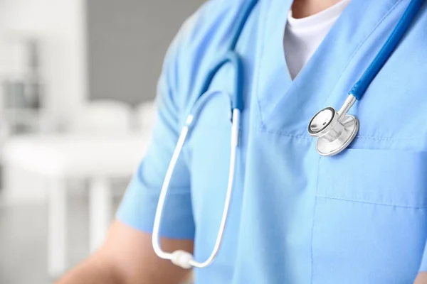 Male nurse with stethoscope in clinic, closeup — Stock Photo, Image