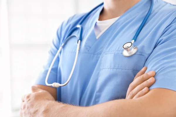 Male nurse with stethoscope in clinic, closeup — Stock Photo, Image