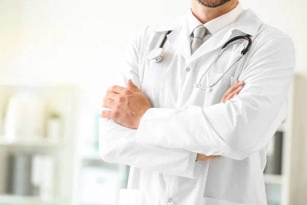 Male doctor with stethoscope in clinic, closeup — Stock Photo, Image