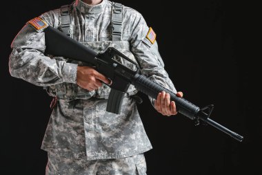 Karanlık arka planda saldırı tüfeği ile Asker