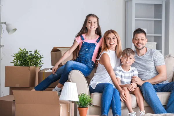 Happy family with belongings in their new house — Stock Photo, Image